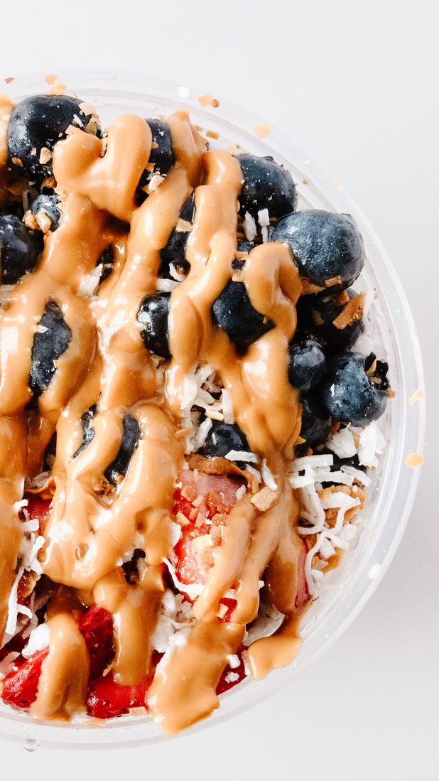 Bowl with peanut butter drizzle and coconut